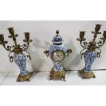 Late 19th C 3 piece clock set, blue and white pottery centres, all damaged, on brass bases,