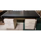 1960s writing table with a black leatherette writing top, turned legs, 51”w x 31”d