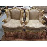 Matching pair of carved gilt wood, mid 20th C armchairs with raised floral detail borders, curved