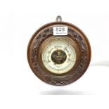 Circular wall barometer in a moulded oak frame, stamped “Mansfield & Sons, Dublin”, 8” dia