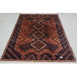 Old blue and red ground Persian Nejafabad Floor Rug, with a cross medallion design, 1.95 m x 1.35m