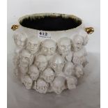 ELEANOR SWAN “Are You Sure”, a Ceramic Jardinière, painted white, decorated with the raised heads of