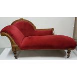 Victorian walnut framed Chaise Longe, with an arched inlaid back and turned legs and castors, red