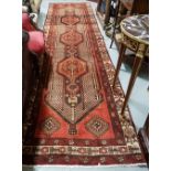 Washed red ground Iranian runner with a traditional Sarouch Mea design, 2.95m x 0.9m