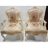Matching Pair of floral silk covered French Style Armchairs, in carved wood cream frames