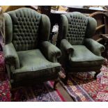 Matching Pair of Highback Armchairs, covered with green suede fabric, buttoned in, on pad feet