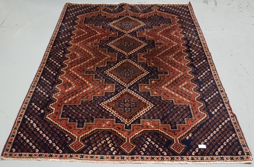Old blue and red ground Persian Nejafabad Floor Rug, with a cross medallion design, 1.95 m x 1.35m