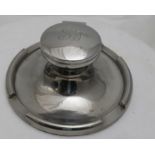 Plated Inkwell Stand, with initialled hinged lid and glass well, on a circular base, 16cm dia