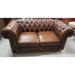 Two-Seater Brown Leatherette Settee, with buttoned roll back, on castors