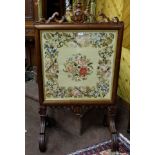 Victorian mahogany framed Fire Screen with carved decorative cartouche about a Berlin wool work