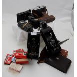 German WW” Daimon flashlight, Goldi folding camera, Agfa Isolette 1 folding camera, Kodak pocket