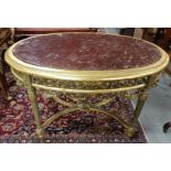 Oval Shaped Gilt Centre Table with an elaborately carved apron (green hues), with an red marble