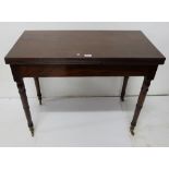 19th C mahogany fold over tea table on 4 turned legs, brass casters, 36”w (extends to 36”sq)