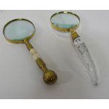 2 modern brass framed magnifying glasses – 1 with a glass handle, 1 brass