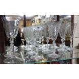 Set of 4 fine glass wine glasses on stems 8.5”h, 2 similar small engraved glasses and 2 plain wine