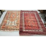 2 floor rugs – one red ground 1.64m x 1.1m & 1 other later rug