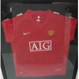 A Manchester United (AIG) Jersey, signed by the team, in a gilt frame (no certificate to accompany)