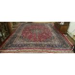 Persian red ground Mashad Carpet, with a traditional medallion design, 4m x 3.06m