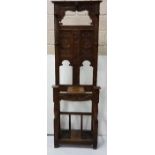 Early 20th C carved oak narrow hallstand, with Roman figures and 5 turned coat hangers, 2 stick