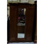 Mahogany wardrobe, the single door framing a mirror, 50”w x 78”h and a similar dressing table with