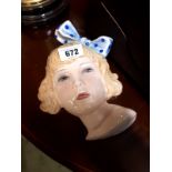 Art Deco ceramic wall plaque in the form of a girl's face.