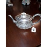 English silver teapot , having a rectangular baluster body decorated with scrolls and foliage ,