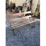 Cast iron garden seat with wooden slats.