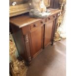 Regency mahogany and rosewood side cabinet the two drawers above two doors flanked by two half