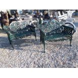 Pair of decorative cast iron garden benches with ram heads.