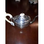 English silver teapot , having a plain baluster body with ivory handle,