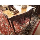 19th. C. mahogany turn over leaf card table with serpentine top raised on tapered legs.