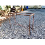 Decorative metal garden table with glass top.