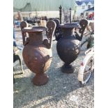 Pair of decorative cast iron garden urns in the Neo - Classical style.