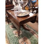 Georgian mahogany double drop leaf sofa table with turned column with four out swept brass feet.