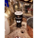 Guinness Ruberoid pint glass advertisement.