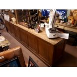 19th. C. scumbled pine shop counter with six raised panels.