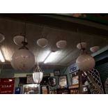 Pair of football milk glass hanging light shades.