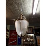 Decorative brass and etched glass lantern in the form of an acorn.