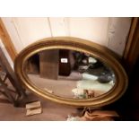 Gilt oval framed mirror.