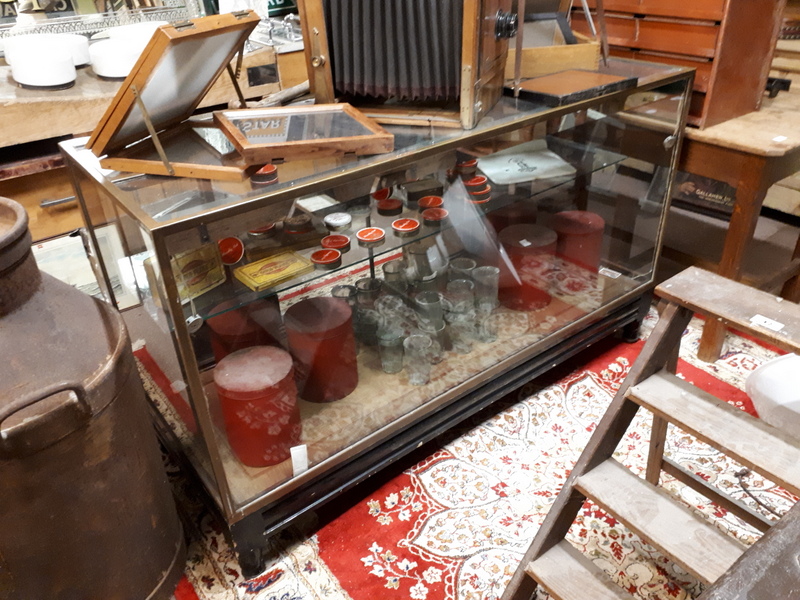 1930's brass and plate glass shop display counter mounted on a mahogany base.