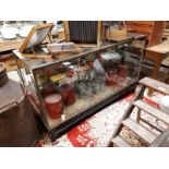 1930's brass and plate glass shop display counter mounted on a mahogany base.