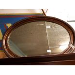 Gilt framed oval wall mirror.