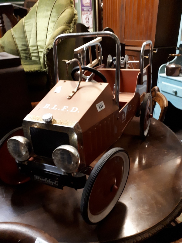 Vintage pedal car in the form of a fire truck.