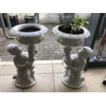 Pair of cast iron cherub planters