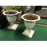 A pair of Regency cast iron urns