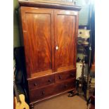 Georgian mahogany two door linen press with two short drawers over one long.