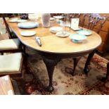 D-end mahogany dining table with four carved legs on claw and ball foot.