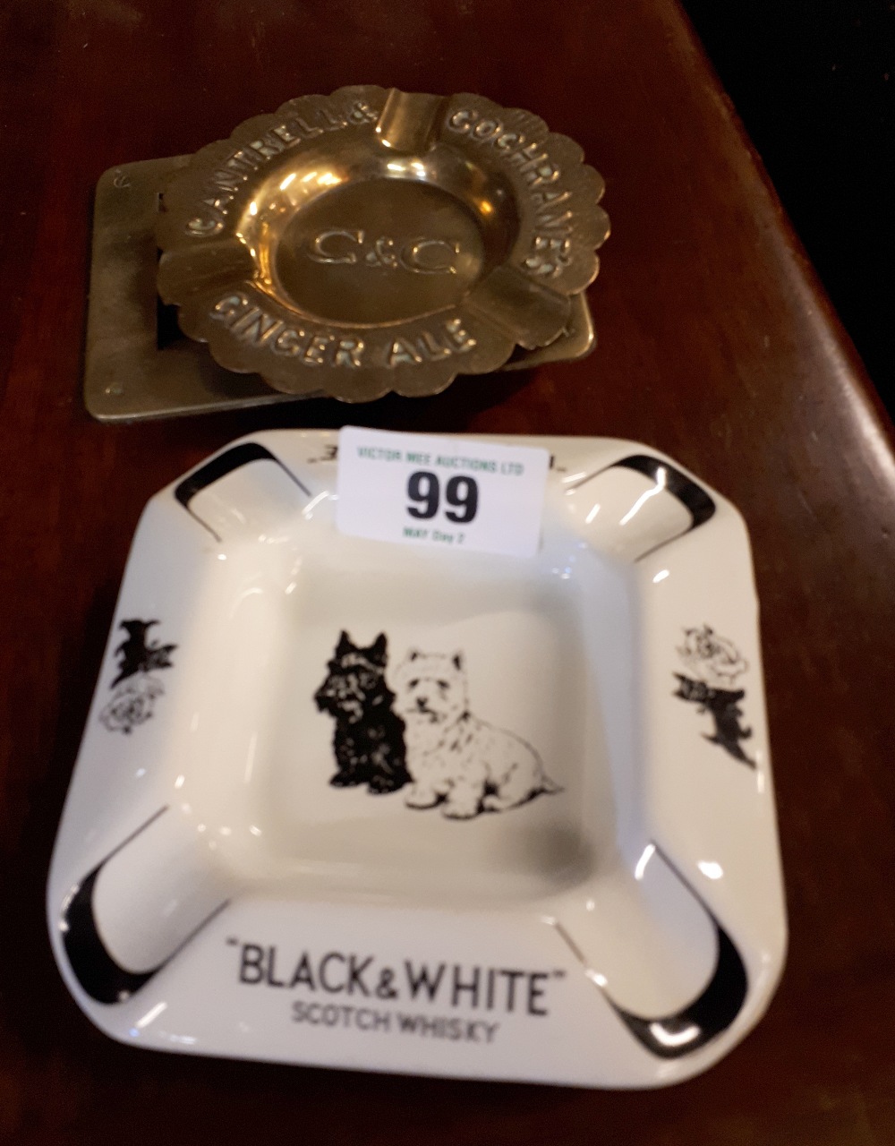 CANTRELL AND COCHRANE brass advertisng ashtray and BLACK AND WHITE enamel ashtray.