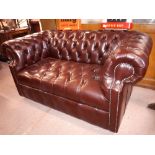 Two seater leather deep button Chesterfield couch.