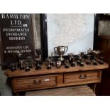 Collection of silver plate trophies.
